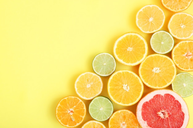 Different citrus and juicy slices on a colored background place to insert text