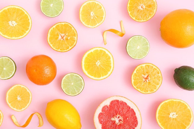 Different citrus and juicy slices on a colored background place to insert text