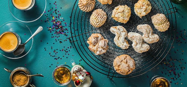 different classic Italian homemade almond cookies with espresso coffee and glasses of sweet liquor on the table