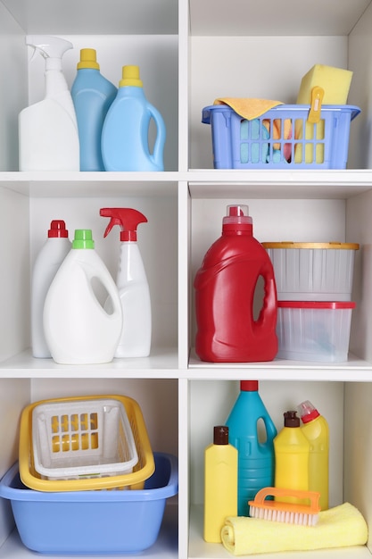 Photo different cleaning supplies and tools on shelves