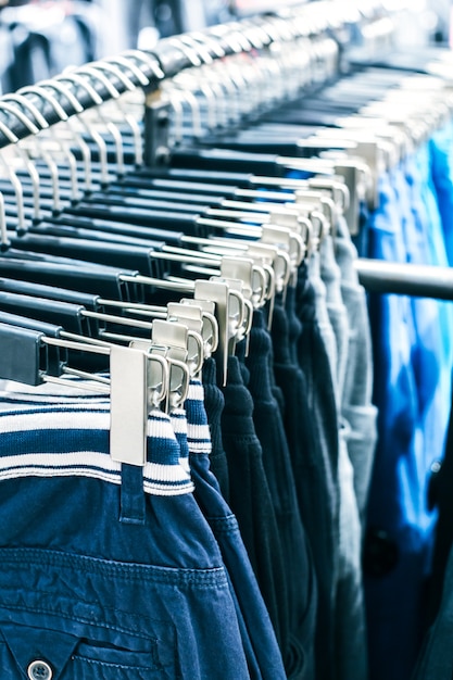 Different clothes on hangers close up