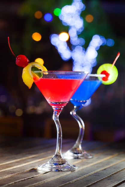 Different cocktails with fruits on wood table at restaurant