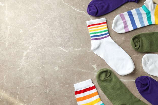 Different color socks on gray textured background