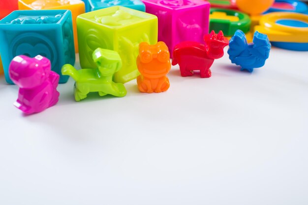 Different colored children toys, cubes on white background