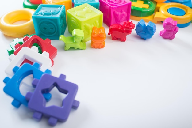 Different colored children toys, cubes on white background