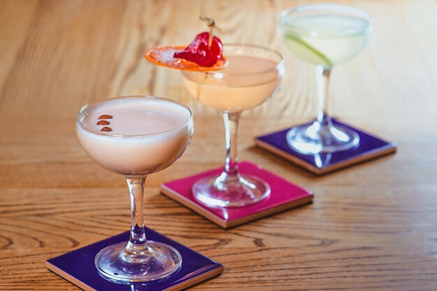 Different colorful alcohol and nonalcohol cocktails in the glasses on the table