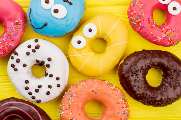 Different colorful donuts with funny faces