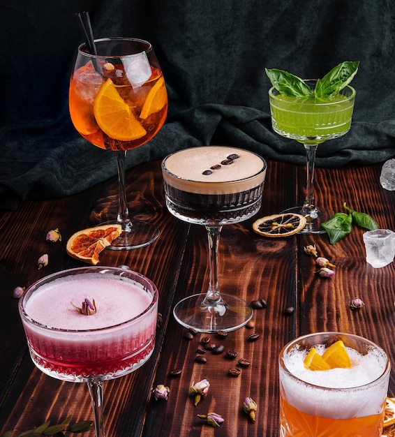 Different colorful exotic alcoholic cocktails on wood