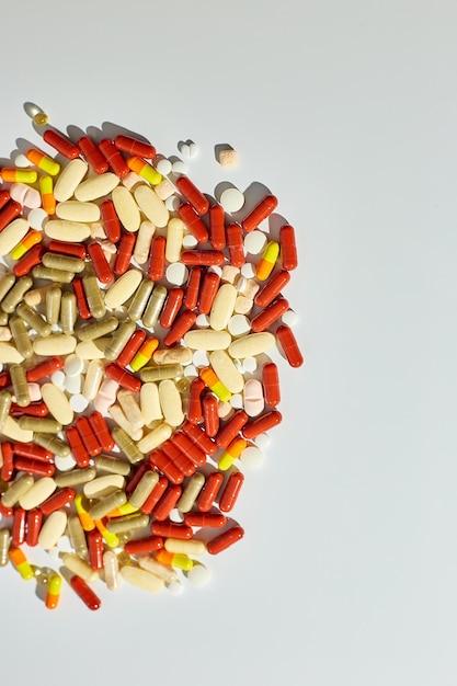 Different colorful pills medical drugs on white background