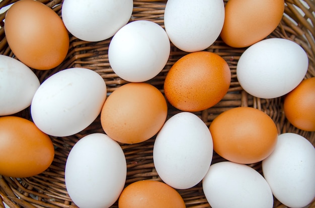 Different colors of chicken eggs in basket