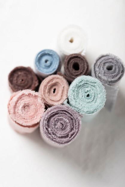 Different colors fabric rolls on the white table selective focus image