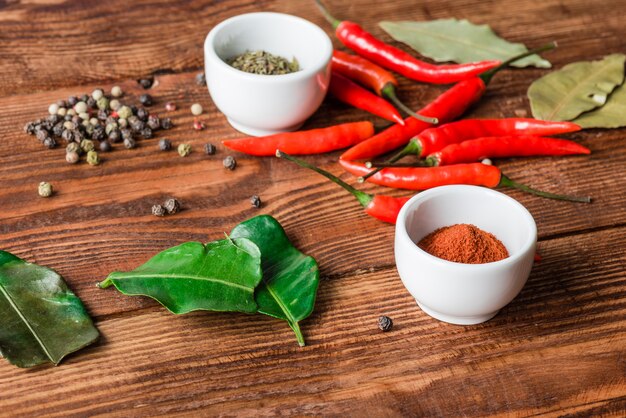 Different condiment in bowls or scattered on kitchen table.