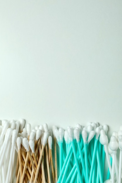 Different cotton swabs on white background, space for text