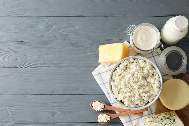 Different dairy products on grey wooden background