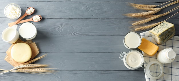 Different dairy products on grey wooden background