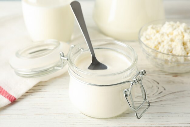 Different dairy products on white wooden background