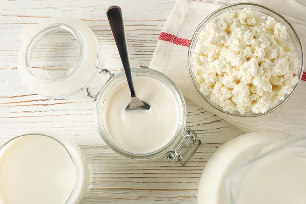 Different dairy products on white wooden background