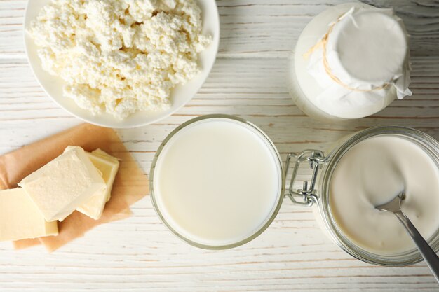 Different dairy products on white wooden background