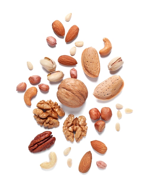 Different delicious nuts on white background flat lay Space for text