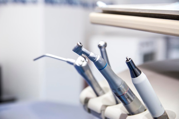 Different dental tools in the dental office. Dental chair instruments. Close-up dentist tools capture.