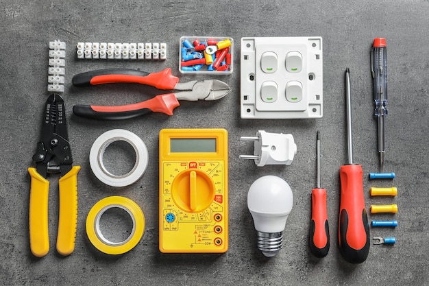 Photo different electrical tools on grey background