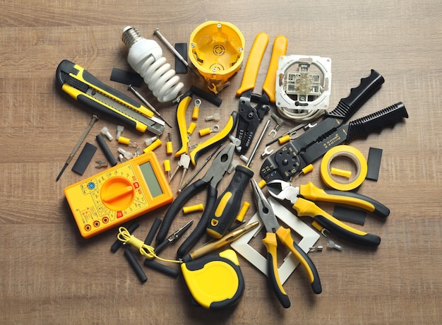 Different electrical tools on wooden background