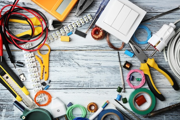 Photo different electrical tools on wooden table top view