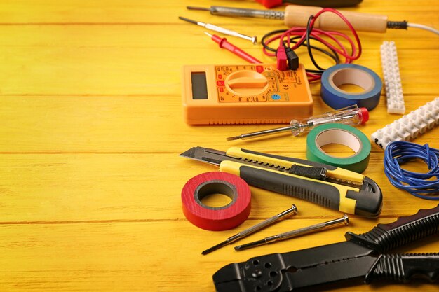 Different electrical tools on wooden table