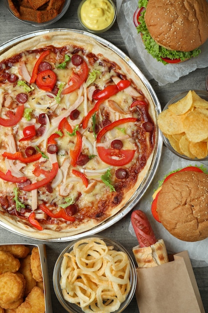 Different fast food on gray textured table