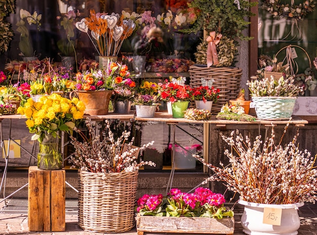 Different flowers and seedlings near the florist flower shop entrance spring time easter concept