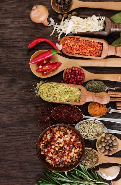 Different fragrant spices and seasoning on wooden background