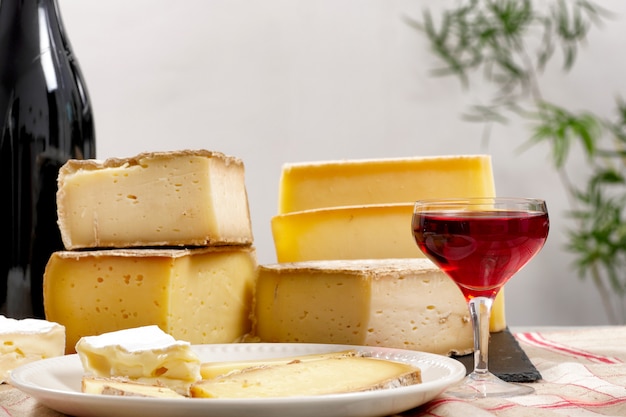 Different french cheeses with a glass of wine