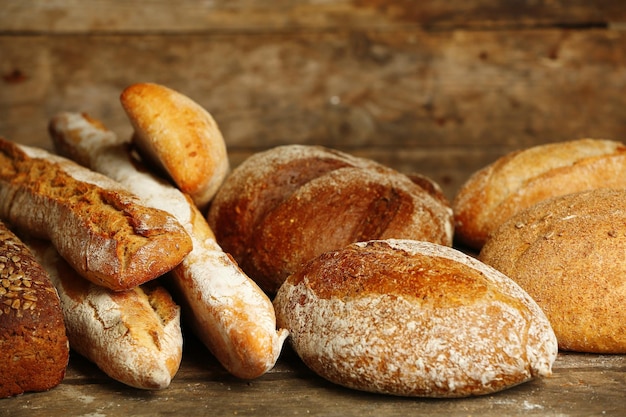 Different fresh bread on old wooden table