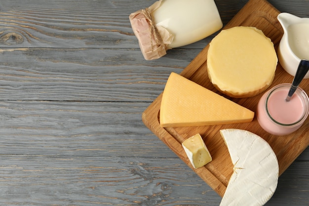 Different fresh dairy products on gray wooden background