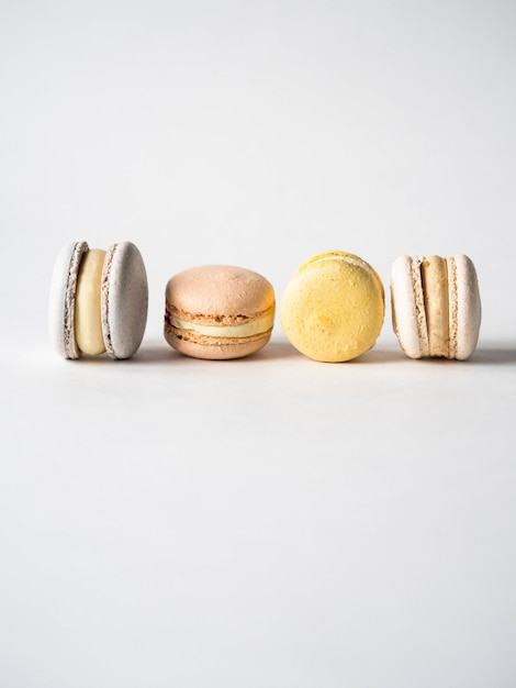 Different fresh french pastel colorful macarons on white background. Copy space