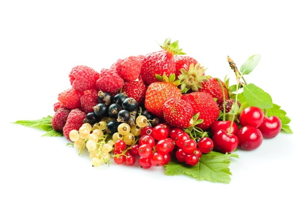 Different fruits and berries heap isolated on white