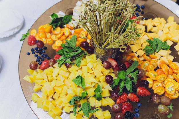 different fruits, berries and vegetables on a plate