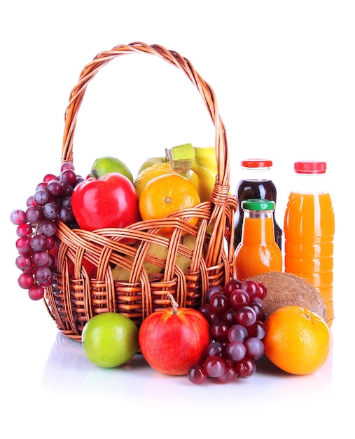 Different fruits in wicker basket with juice isolated on white