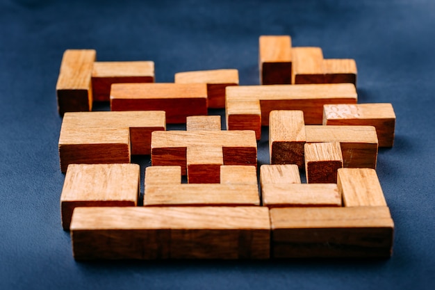 Different geometric shapes wooden blocks on a dark background