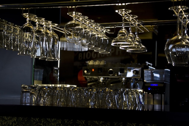 Different glasses in rack at bar