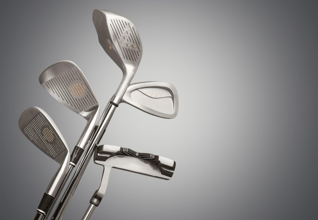 Different golf clubs on blurred background