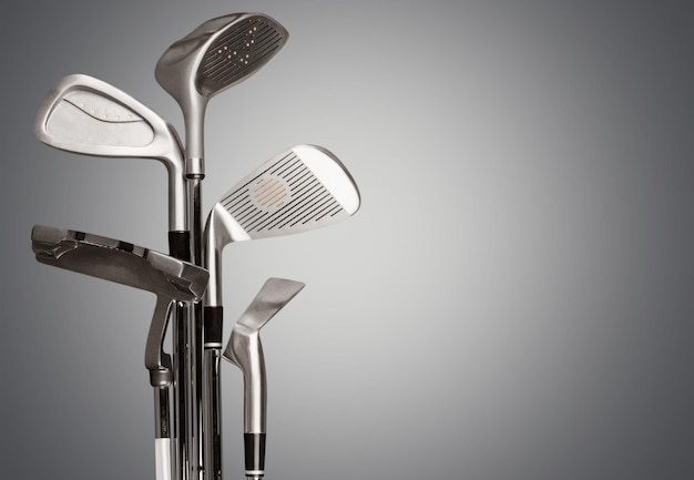 Different golf clubs isolated on background