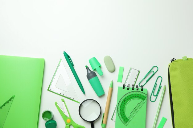 Different green stationery on white background, space for text