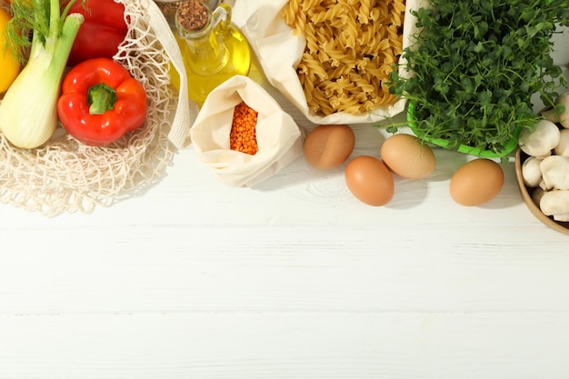 Different grocery on white wooden table space for text