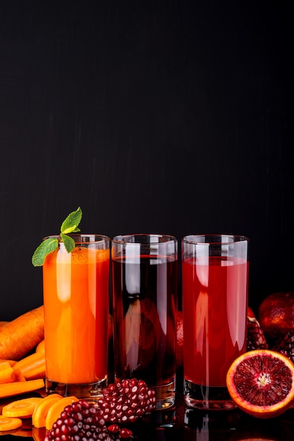 Different healthy vegan drinks on the black background Raw drinks and foods