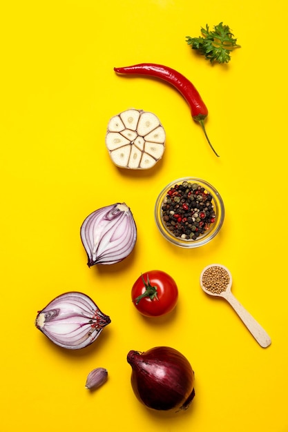 Different ingredients for cooking on yellow background