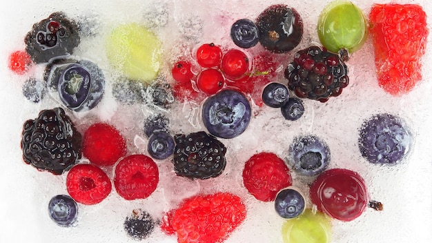 Different juicy berries frozen in ice. vitamin healthy food