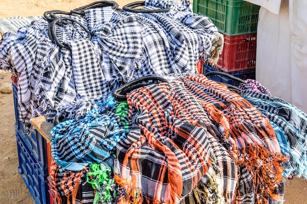 Different keffiyeh traditional arabian headdress for sale in a street shop