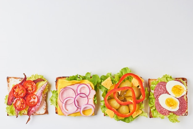 Different kind of sandwich on a white background, top view