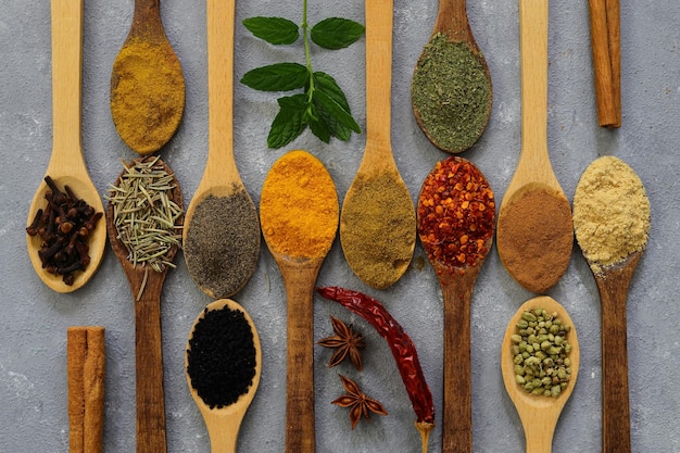 Different kind of spices on a wood background Big set of Indian spices on wooden table